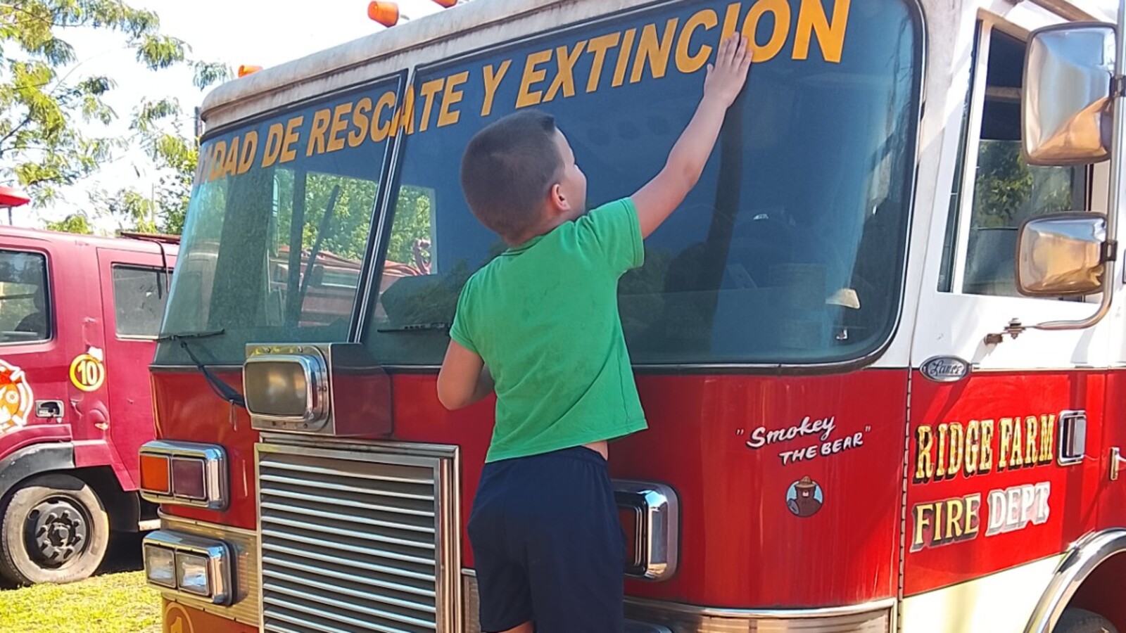 Sam exploring a fire truck during a day trip to Capiata, Paraguay.