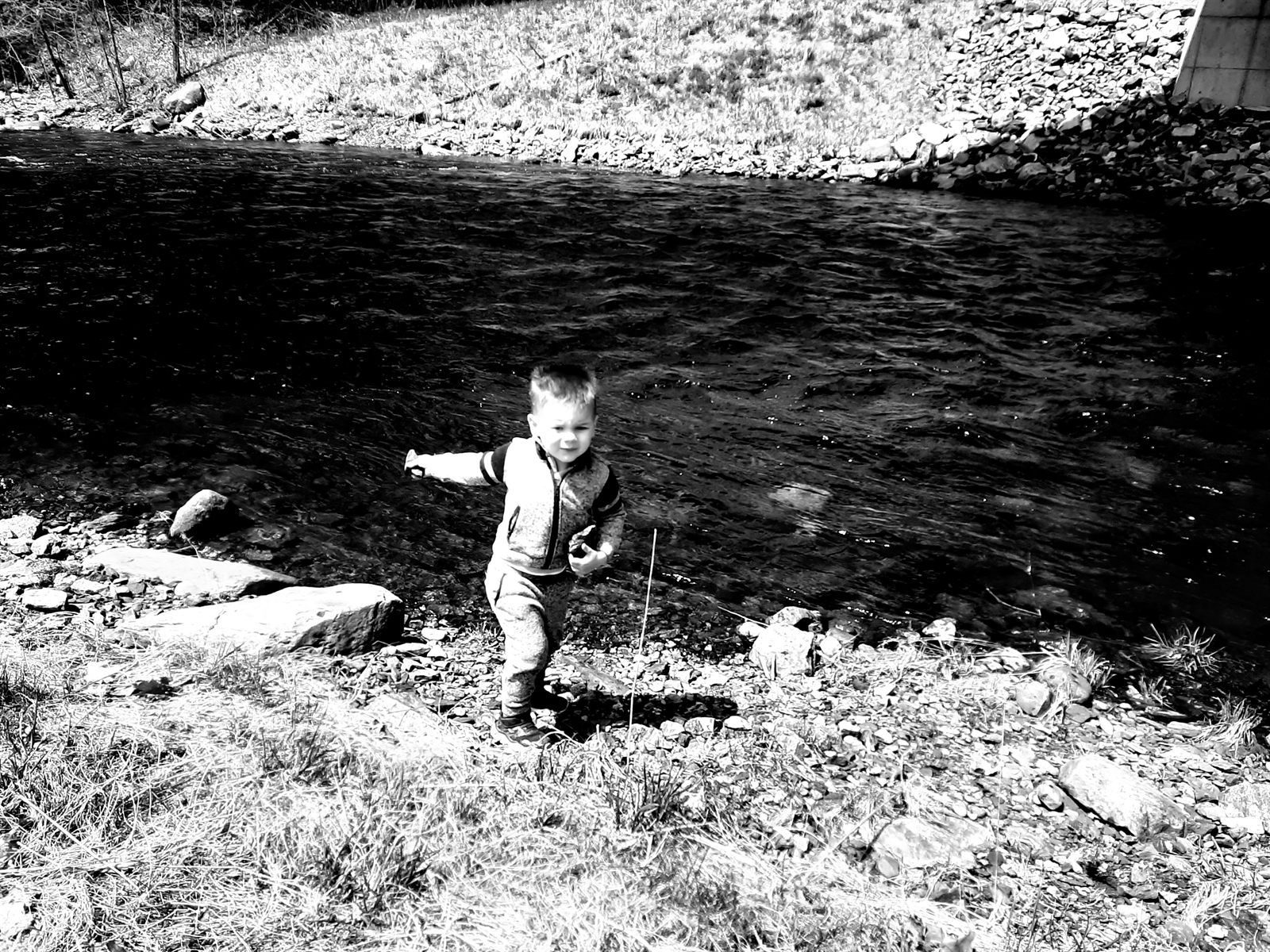 A younger Sam happily exploring beside a creek, showing why lifelong planning begins long before adulthood.