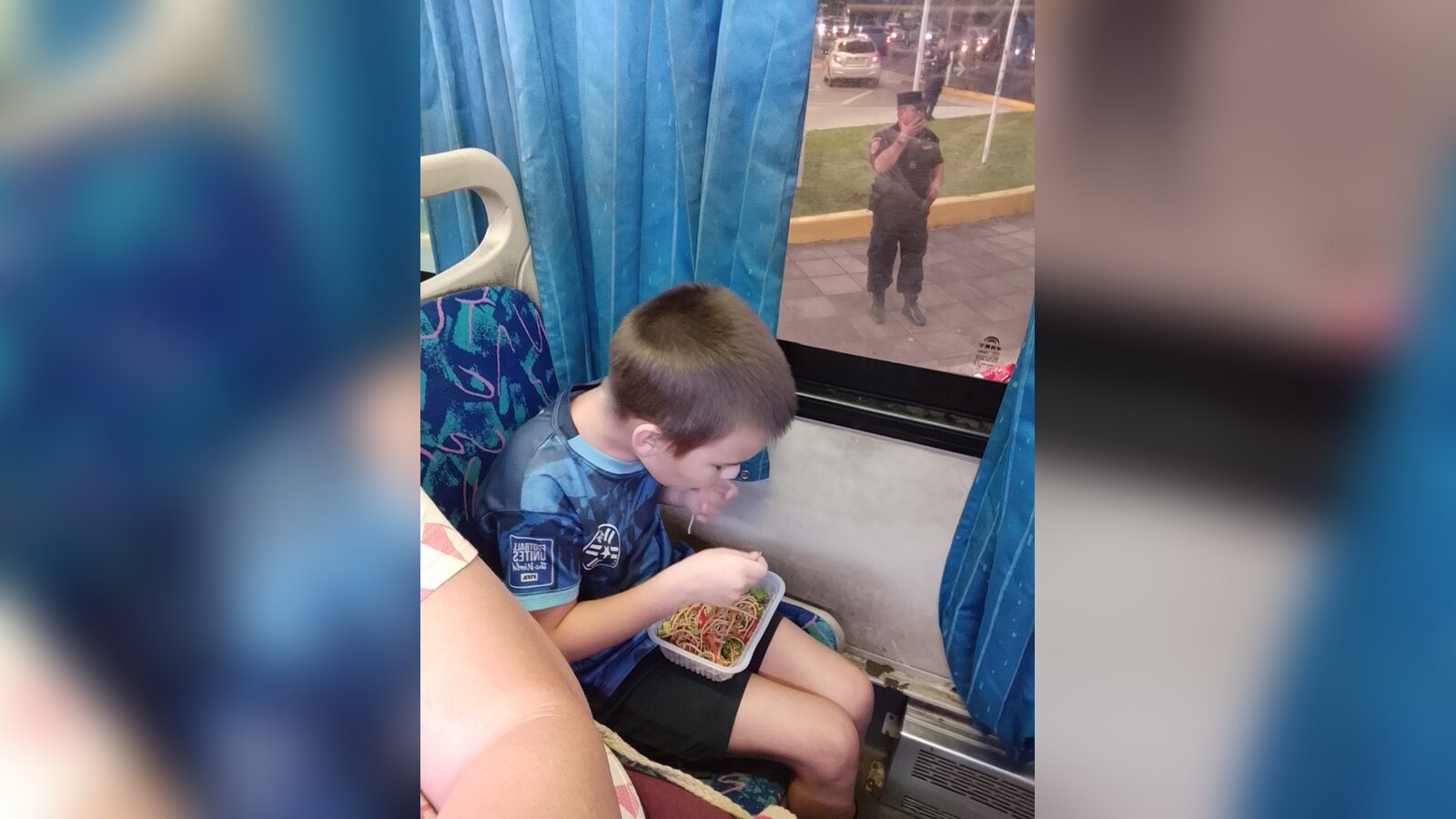 Samuel eating dinner from a small takeout container while riding the Line 56 bus home to San Lorenzo, Paraguay.