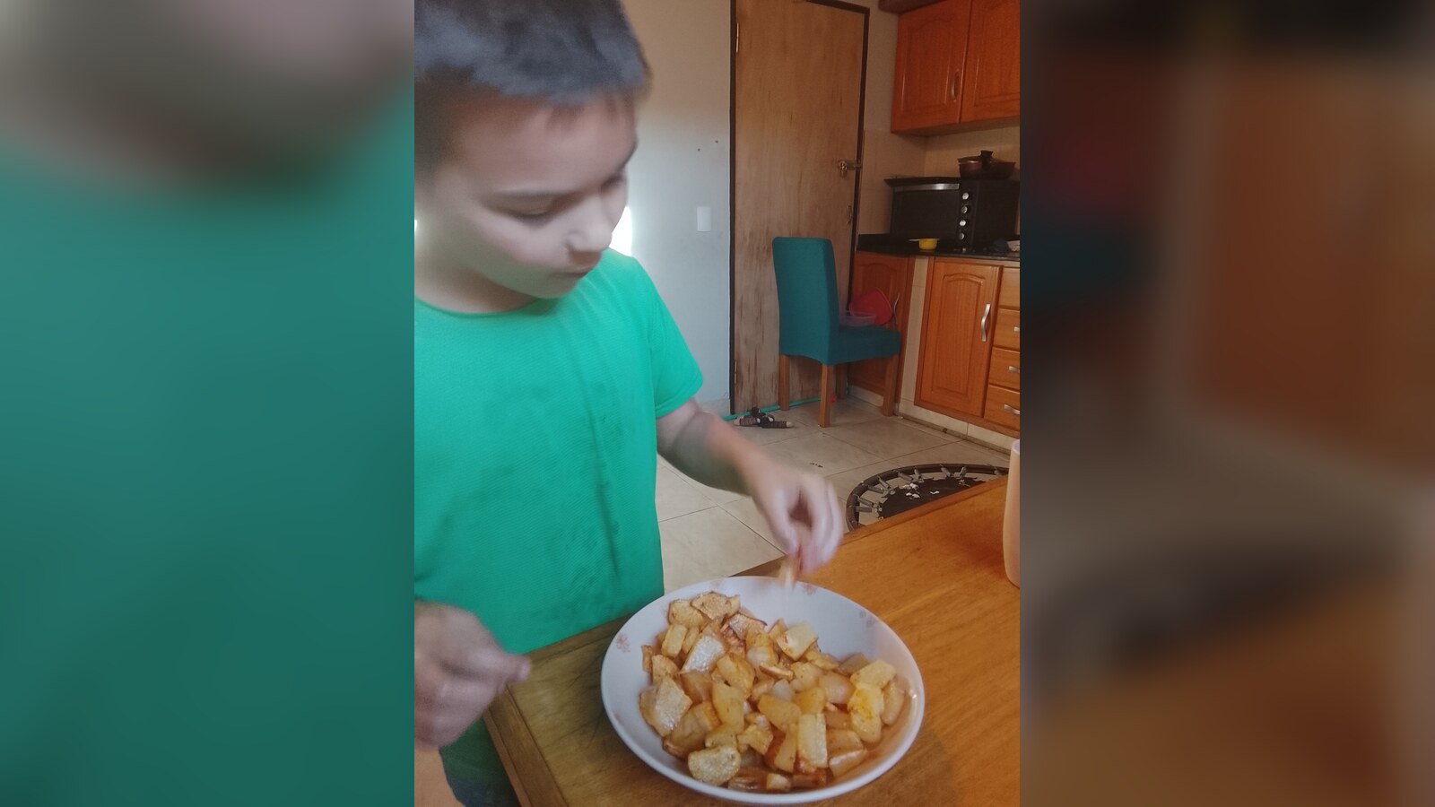 Sam tasting a plate of fried mandioca prepared with paprika and salt.